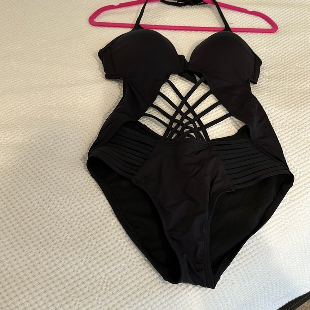 Black Kenneth Cole one-piece bathing suit. Lined cups. Tie neck and back.